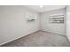 Bedroom features gray carpet, light walls and natural light from two windows at 2021 Canal Rd, Deltona, FL 32738