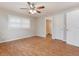 Cozy bedroom with natural light, ceiling fan, and hardwood floors at 2021 Canal Rd, Deltona, FL 32738