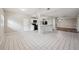 Modern kitchen with white cabinetry, a breakfast bar, and a view into the living area at 2021 Canal Rd, Deltona, FL 32738