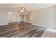 Open living area featuring gray wood floors, neutral paint, and a ceiling fan at 2021 Canal Rd, Deltona, FL 32738