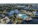 An aerial view of the community pool, clubhouse, parking, and lake at 2023 Grand Oak Dr, Kissimmee, FL 34744