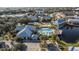 An aerial view of the community pool, clubhouse, parking, and lake at 2023 Grand Oak Dr, Kissimmee, FL 34744