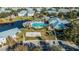 Aerial view of the community pool, clubhouse, volleyball court, playground, parking, and lake at 2023 Grand Oak Dr, Kissimmee, FL 34744