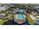 An aerial view shows community amenities: pool, clubhouse, playground, parking, and deck overlooking the lake at 2023 Grand Oak Dr, Kissimmee, FL 34744