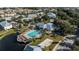 Aerial view of community pool, clubhouse, volleyball court, playground, parking, and deck overlooking the lake at 2023 Grand Oak Dr, Kissimmee, FL 34744