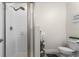 Well-lit bathroom with a glass-enclosed shower, modern toilet, and charming decor at 2023 Grand Oak Dr, Kissimmee, FL 34744