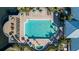 Aerial view of a large community pool surrounded by lounge chairs and umbrellas at 2023 Grand Oak Dr, Kissimmee, FL 34744