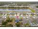 An aerial view of the backyard including a well-manicured lawn near a beautiful pond in a suburban neighborhood at 2067 Buckhanon Trl, Deland, FL 32720