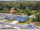 A sunny aerial view of a charming blue home with red shutters, nestled in a neighborhood with tree-lined streets at 2067 Buckhanon Trl, Deland, FL 32720