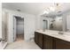 Bathroom with double vanity, large mirror, and tiled shower at 2067 Buckhanon Trl, Deland, FL 32720