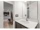 Bathroom featuring a single vanity with a white countertop and a decorative vase, with kitchen view at 2067 Buckhanon Trl, Deland, FL 32720