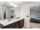 Bathroom featuring a double sink vanity with quartz countertop and a large mirror at 2067 Buckhanon Trl, Deland, FL 32720