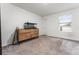 Bedroom with neutral walls, carpeted floors, a window, and a dresser with an aquarium, offering a calm vibe at 2067 Buckhanon Trl, Deland, FL 32720