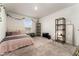 Bright bedroom featuring neutral carpet, a large window, and decorative vines at 2067 Buckhanon Trl, Deland, FL 32720