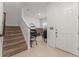 Bright foyer featuring a staircase, tile flooring, and a white front door leading into the home at 2067 Buckhanon Trl, Deland, FL 32720