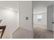 Upstairs hallway with a view into a carpeted bedroom with lots of sunlight, with a door ajar at 2067 Buckhanon Trl, Deland, FL 32720