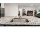 Close-up of kitchen island, highlighting granite countertops, a stainless steel sink, and an open concept layout at 2067 Buckhanon Trl, Deland, FL 32720