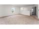 Spacious loft area with neutral carpeting and natural light from the window at 2067 Buckhanon Trl, Deland, FL 32720