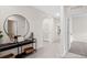 Inviting foyer with tile flooring, a decorative mirror, and a glimpse of the home's open layout at 2149 Pigeon Plum Dr, Haines City, FL 33844