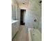 Bathroom featuring a shower, bathtub, and vanity with marble tiling at 220 Palm Ave, Auburndale, FL 33823