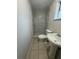 Bathroom featuring a sink, toilet, and marble-tiled walk-in shower at 220 Palm Ave, Auburndale, FL 33823