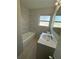 Bathroom featuring tub and shower combo, toilet, and vanity with sink at 220 Palm Ave, Auburndale, FL 33823