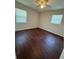 Comfortable bedroom with natural light from two windows, featuring hardwood floors at 220 Palm Ave, Auburndale, FL 33823