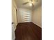 Bedroom features hardwood floors, a ceiling fan, and a built-in shelving unit at 220 Palm Ave, Auburndale, FL 33823