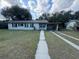 Charming single story home with a front yard and driveway at 220 Palm Ave, Auburndale, FL 33823