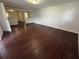 Spacious living room boasting sleek hardwood flooring and ample natural light at 220 Palm Ave, Auburndale, FL 33823