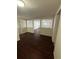 Living room with hardwood floors, neutral walls, and an open doorway at 220 Palm Ave, Auburndale, FL 33823