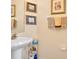 Close-up of a well-lit bathroom vanity with modern fixtures and towel racks at 221 Chippendale Ter, Oviedo, FL 32765