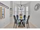 Charming breakfast nook with a round glass table, decorative chandelier, and window shutters at 221 Chippendale Ter, Oviedo, FL 32765