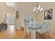 Elegant dining room with hardwood floors, modern chandelier, and comfortable seating at 221 Chippendale Ter, Oviedo, FL 32765