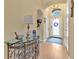 Inviting entryway with hardwood floors, glass console table, and arched doorway at 221 Chippendale Ter, Oviedo, FL 32765