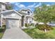 Charming two-story home with stone accents, well-manicured lawn, and attached garage at 221 Chippendale Ter, Oviedo, FL 32765