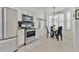 Modern kitchen flowing into breakfast nook, featuring stainless appliances and elegant decor at 221 Chippendale Ter, Oviedo, FL 32765