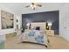 Serene main bedroom featuring a plush bed, accent wall, and abundant natural light at 221 Chippendale Ter, Oviedo, FL 32765