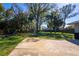 Large backyard with mature trees and green grass at 2401 S Myrtle Ave, Sanford, FL 32771