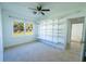 Cozy bedroom with built-in shelving, natural light, and neutral carpeting at 2401 S Myrtle Ave, Sanford, FL 32771