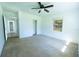 Bedroom with neutral carpet and a closet, adjacent to a hallway at 2401 S Myrtle Ave, Sanford, FL 32771