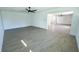 Expansive living area with light-colored hardwood flooring and a ceiling fan at 2401 S Myrtle Ave, Sanford, FL 32771