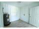 Bright utility room with white walls, tiled flooring, and a water heater at 2401 S Myrtle Ave, Sanford, FL 32771