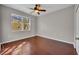 Bright bedroom features a ceiling fan and hardwood floors; lots of natural light through the large window at 2425 Legacy Lake Dr # 2425, Maitland, FL 32751