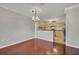 Cozy dining area adjacent to the kitchen, featuring hardwood floors and a chandelier, ideal for Gathering meals at 2425 Legacy Lake Dr # 2425, Maitland, FL 32751