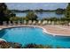 Community pool with lounge chairs and lake views at 2425 Legacy Lake Dr # 2425, Maitland, FL 32751