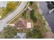 Aerial view of a property near a lake, showcasing the roof, yard, and surrounding landscape at 2753 Joseph Cir, Oviedo, FL 32765