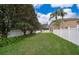 Large backyard featuring green grass, mature trees, and white vinyl fence at 2753 Joseph Cir, Oviedo, FL 32765