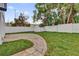 Backyard with a brick paver path, fresh grass, a storage shed, and a privacy fence at 2923 Cornell Ave, Orlando, FL 32804