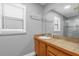 Well-lit bathroom featuring a single sink vanity with tile countertop and a large mirror at 2923 Cornell Ave, Orlando, FL 32804